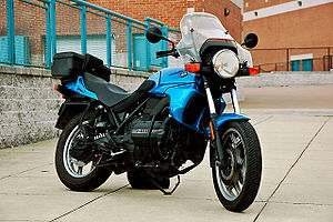 Blue BMW K75 fitted with topbox, parked in a pedestrian area